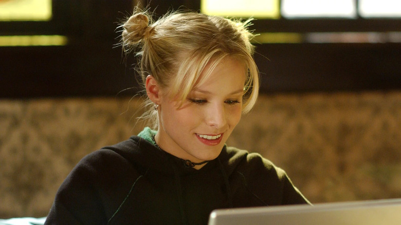 Veronica smiling at laptop space buns
