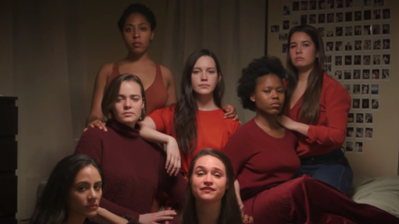 Pedretti sits with a group of women