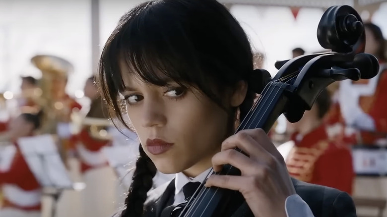Jenna Ortega as Wednesday playing cello