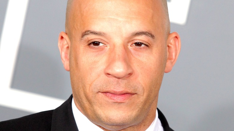 Vin Diesel posting in a suit