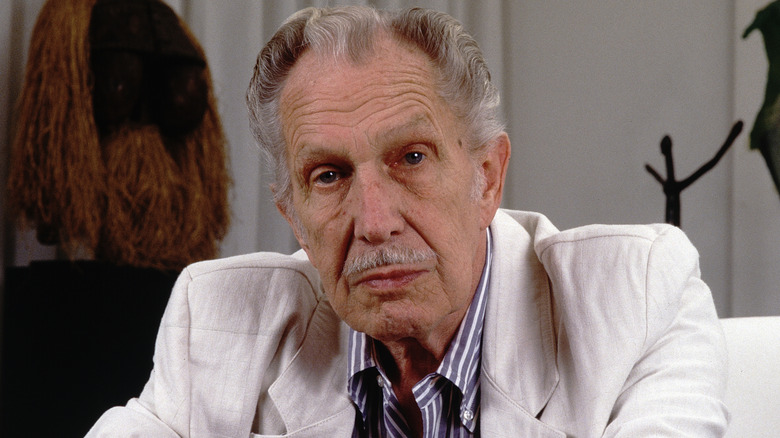 Vincent Price stares into the camera in a white jacket