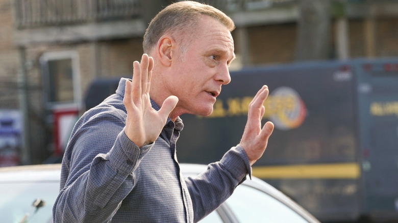 Hank Voight putting hands up