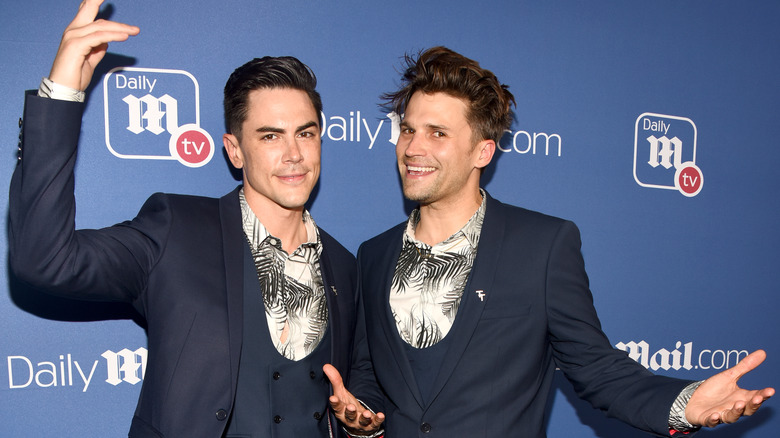 Tom Sandoval and Tom Schwartz smiling together on red carpet