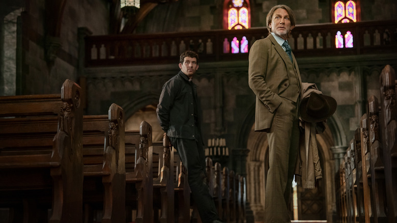 Jud and Benoit stand in church together in "Wake Up Dead Man: A Knives Out Mystery" (2025)