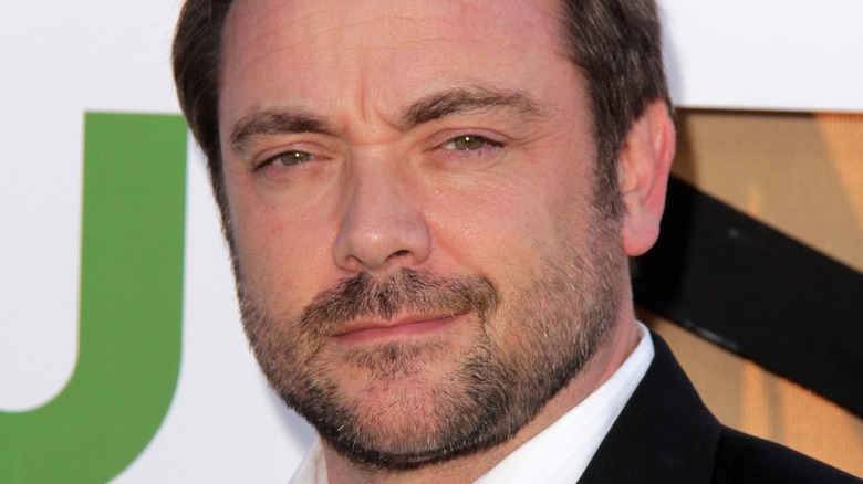 Mark Sheppard smirking