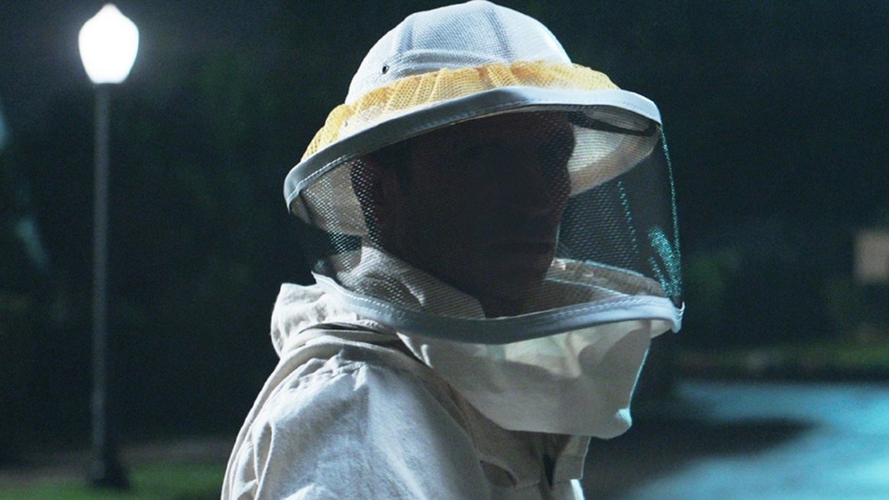 The beekeeper on a dark street