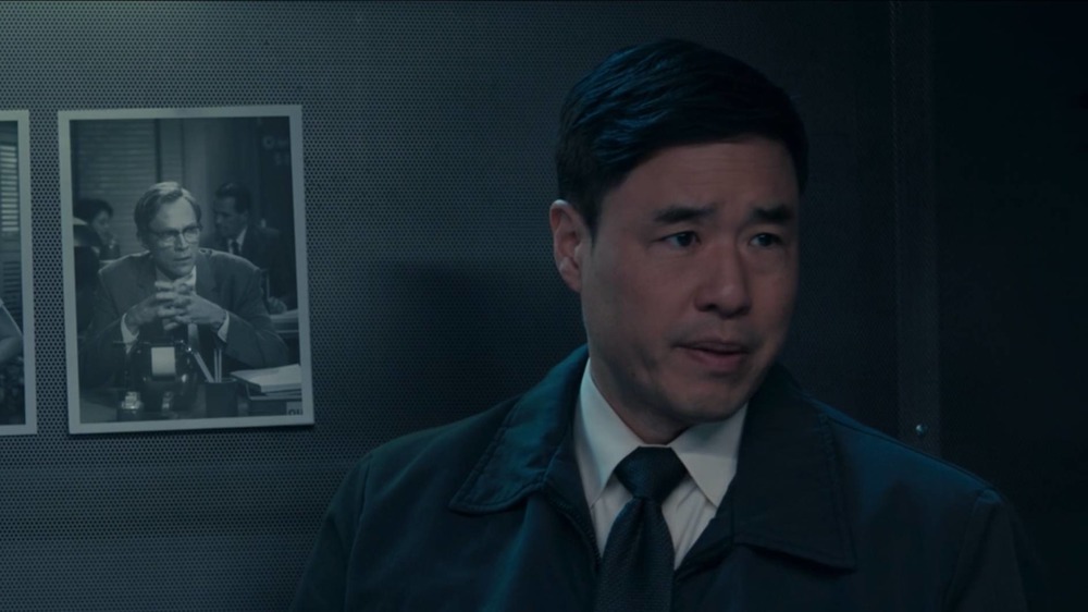 Jimmy Woo stands in front of a picture of Vision