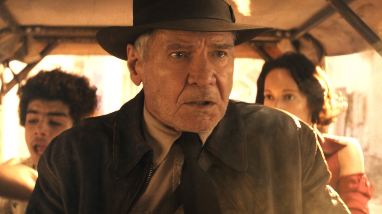 Indiana Jones in a vehicle with Teddy and Helena