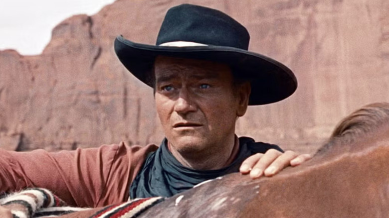 Ethan Edwards looks over his horse in The Searchers (1956)