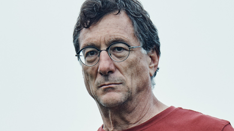 Marty Lagina stares into the distance with a gray sky behind him