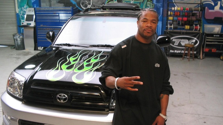 Xzibit in front of modded car