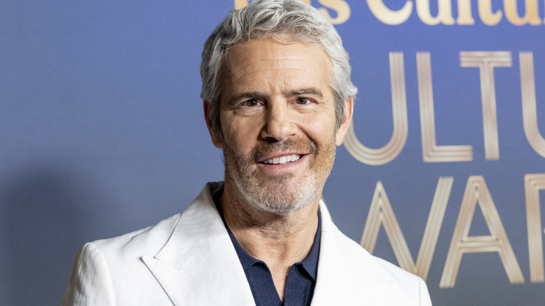 Andy Cohen smiling on the red carpet in 2025