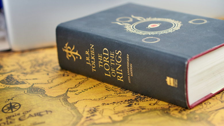 A copy of The Lord of the Rings on top of a Middle-earth map