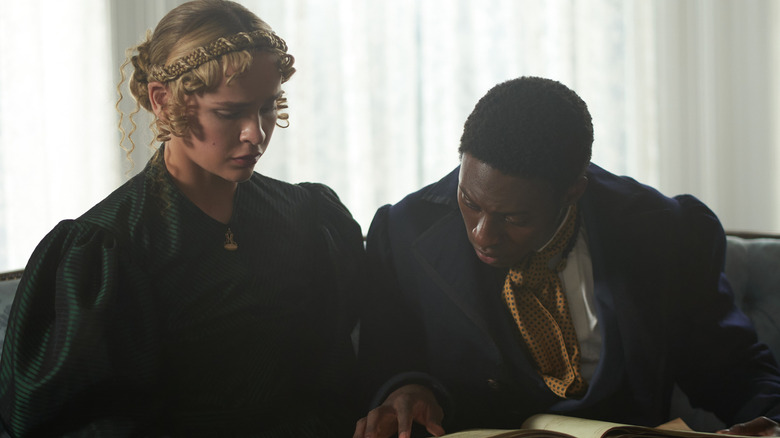 Adult Wash and Tanna looking at book