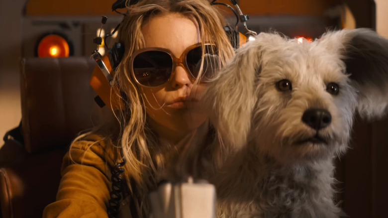 Krypto sitting on Kara Zor-El's lap in Supergirl