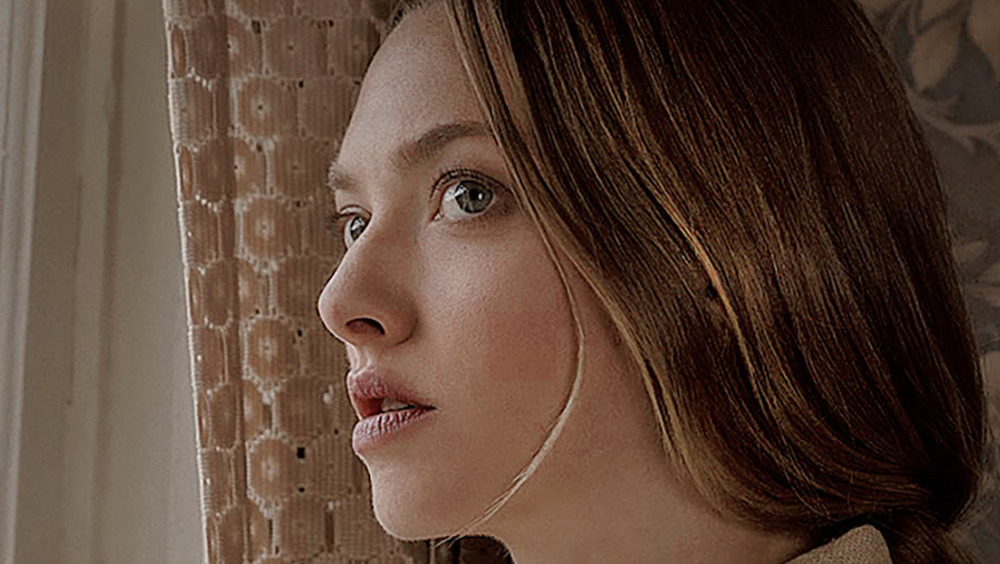 Amanda Seyfried stares out a window