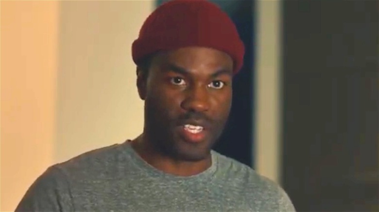 Yahya Abdul-Mateen II in a red hat