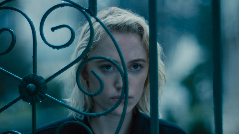 Julia looking through a gate