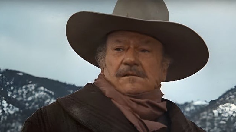 J.B. Books standing in front of snowy hills in "The Shootist."