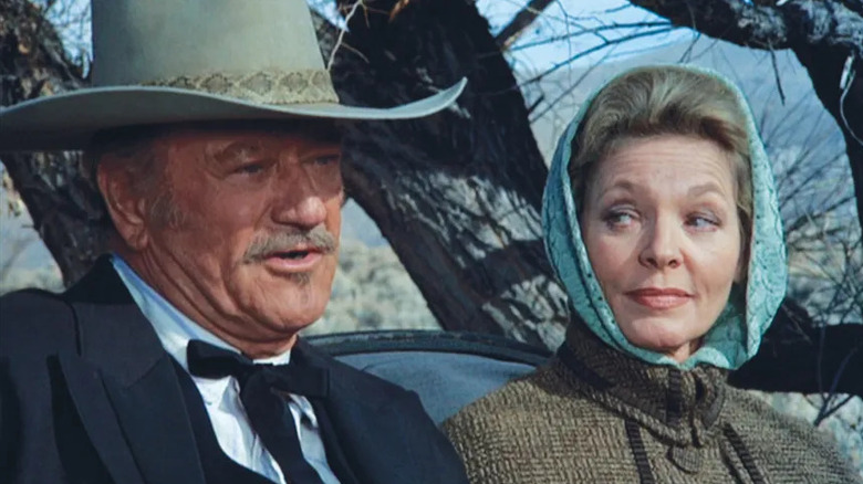 J.B. Brooks (John Wayne) and Bond (Lauren Bacall) sitting together in "The Shootist"
