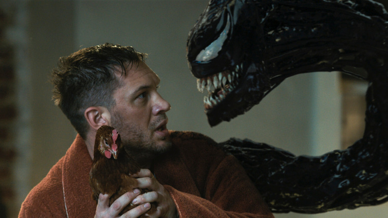 Tom Hardy as Eddie Brock holding chicken