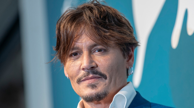 Johnny Depp wearing a white shirt and blue blazer