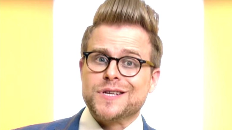 Adam Conover smiles on Adam Ruins Everything