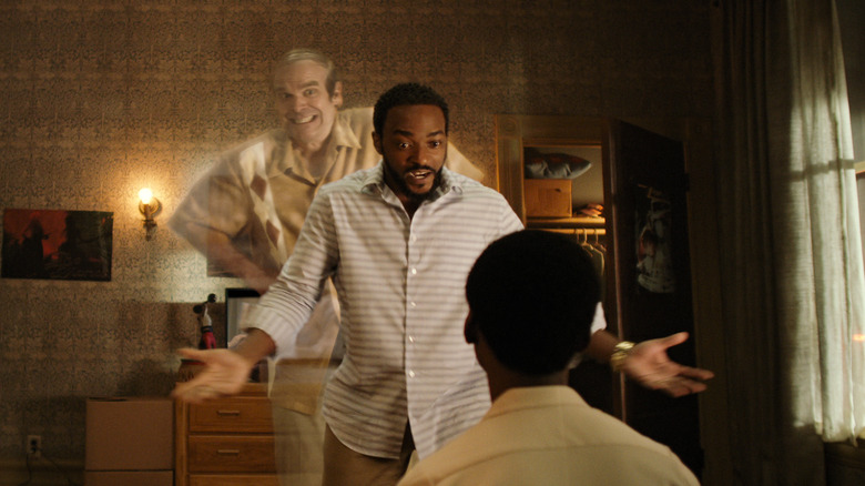 Ernest standing behind Frank