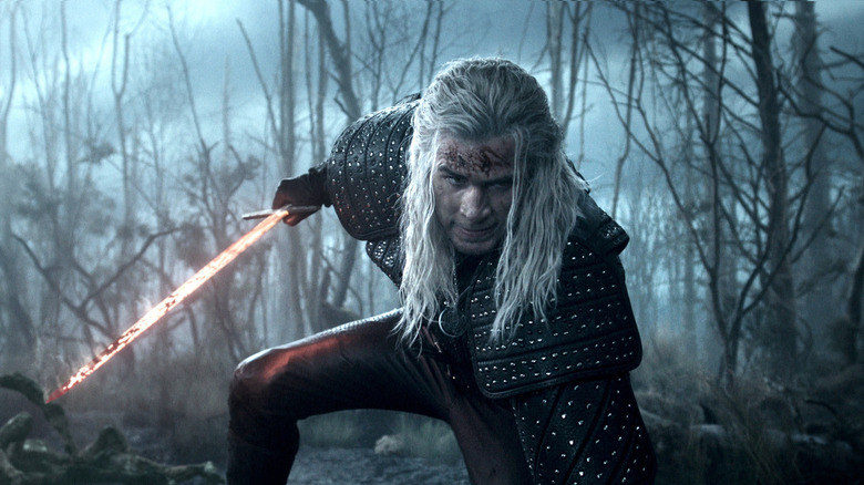 Liam Hemsworth's Geralt of Rivia holding his sword in The Witcher