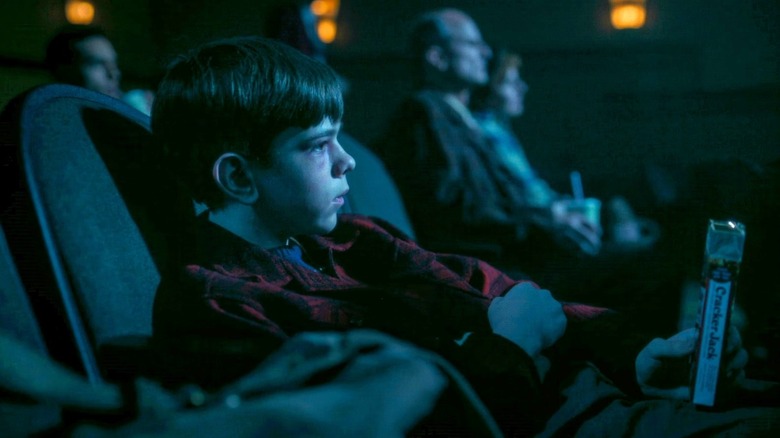 Miles Ekhardt's Matty sitting in a movie theater in It: Welcome to Derry