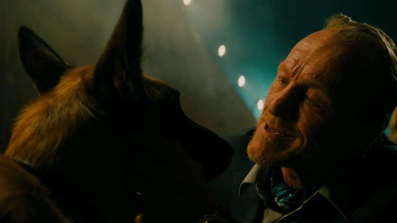 A man scratches a dog behind the ears in "John Wick: Chapter 3 -- Parabellum" (2019)
