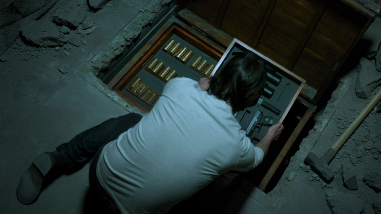 John puts coins and guns in his floor safe in "John Wick" (2014)