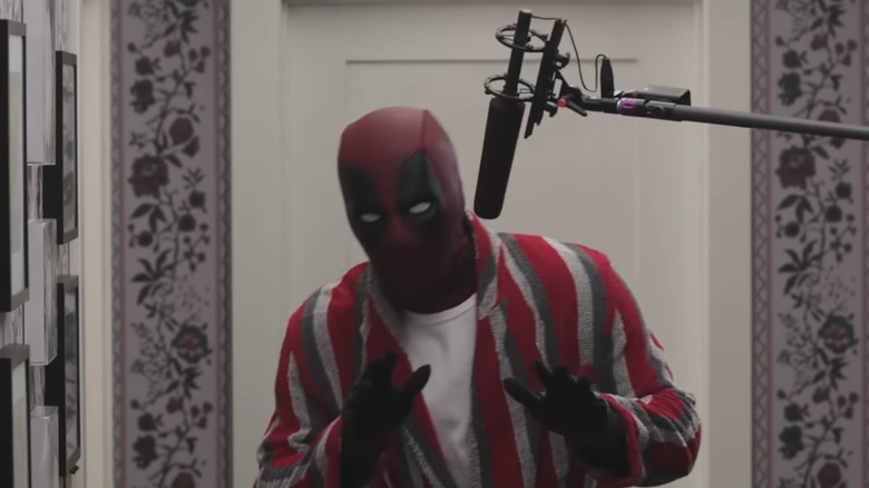 Deadpool speaking into a boom mic