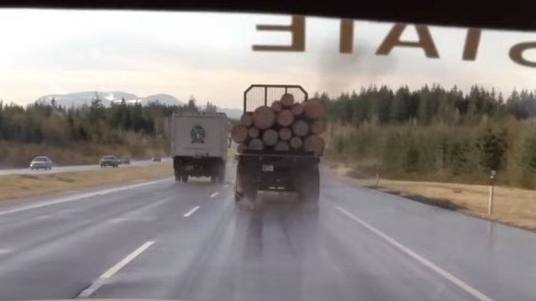 A cop driving behind the log truck in Final Destination 2