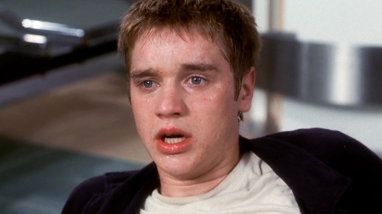 Alex Browning on the floor of an airport after exiting a doomed plane