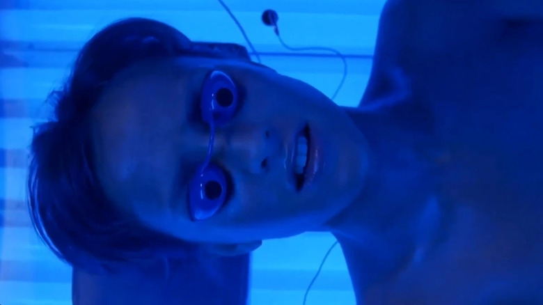 Ashlyn inside of a tanning bed in Final Destination 3