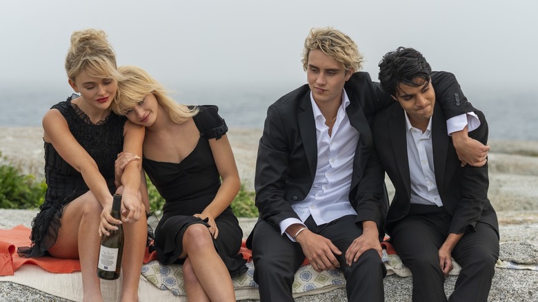 The Liars — Cadence, Mirren, Johnny, and Gat — sitting together on the beach