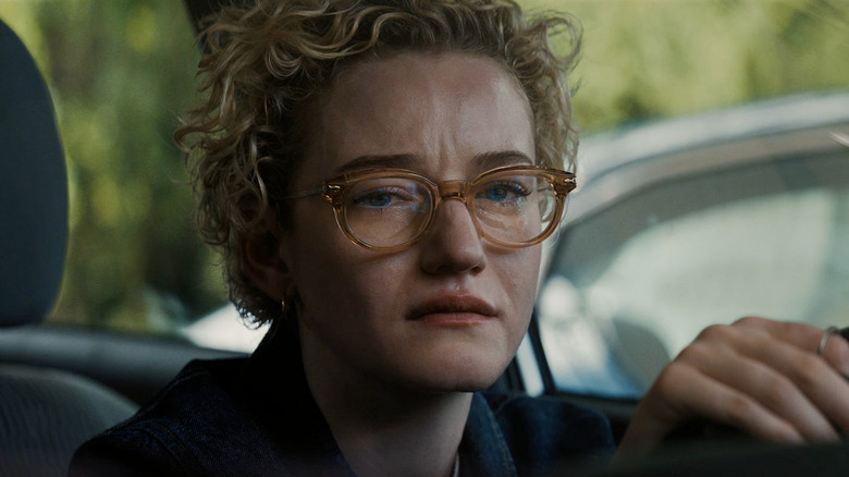 Justine at the wheel of her car crying in Weapons