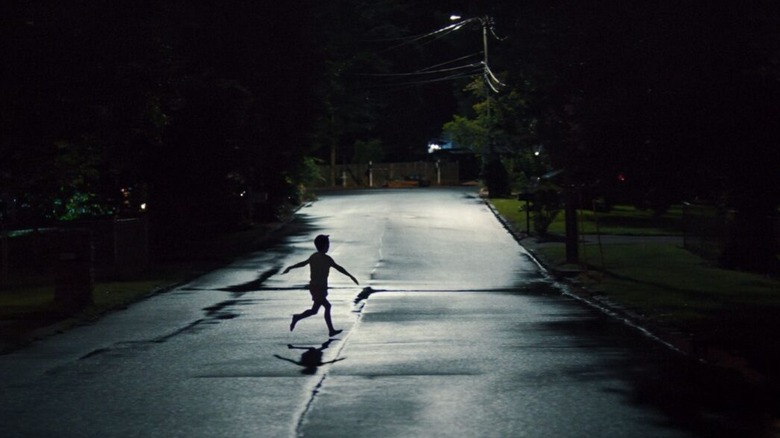 Kid running down the road in Weapons