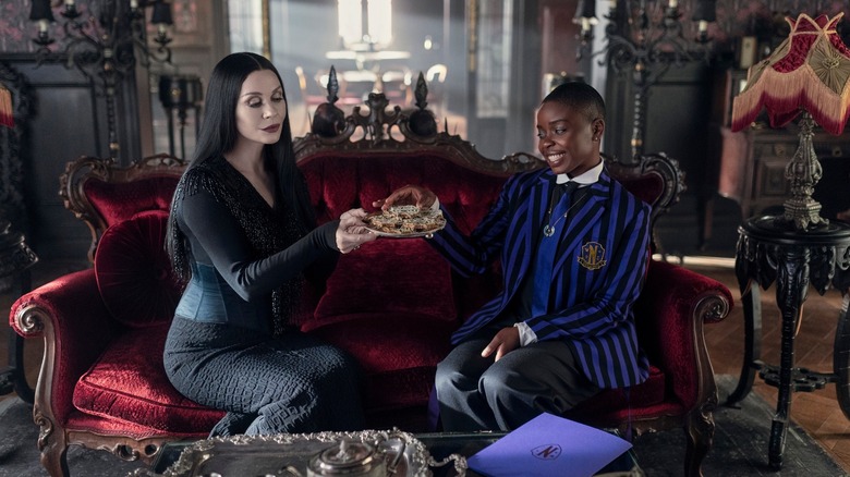 Morticia and Bianca enjoying cookies in the Addams-redesigned Gardener's Cottage (2025)