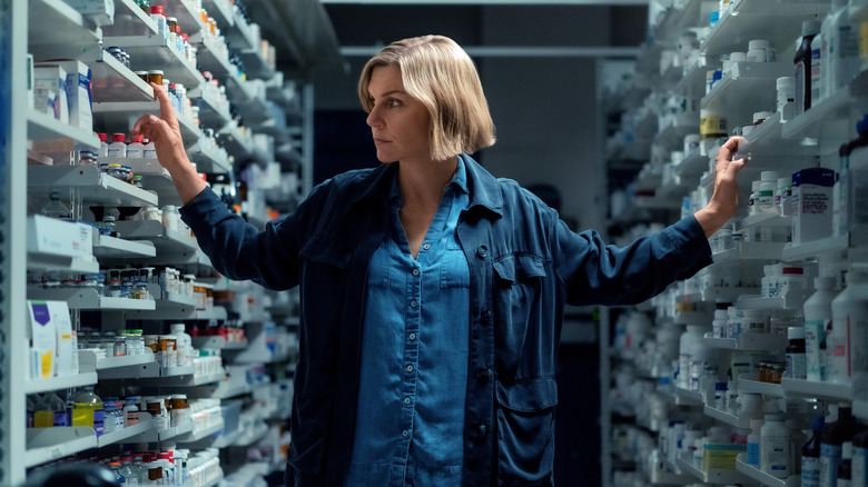 Carol in a pharmacy checking the shelves on Pluribus