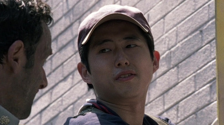 Glenn Rhee wearing red hat