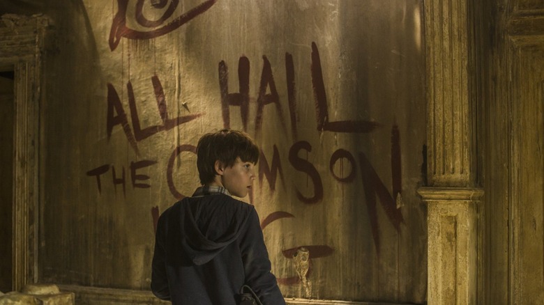 Jake Chambers standing in front of graffiti
