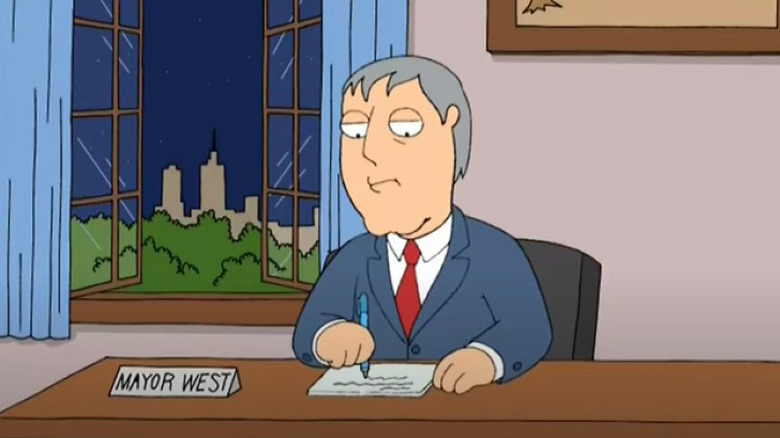Mayor West writing at his desk