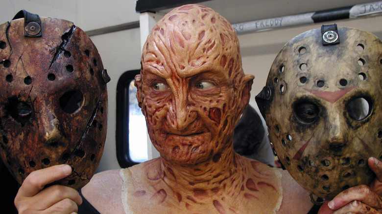 Robert Englund as Freddy holding Jason Voorhees masks