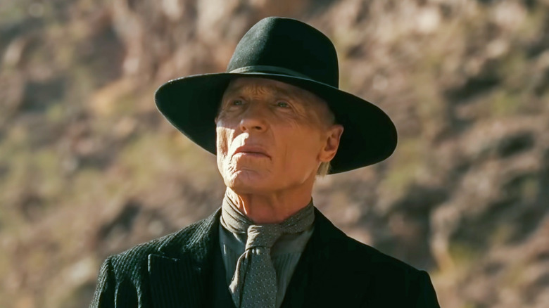 Man in Black outdoors staring