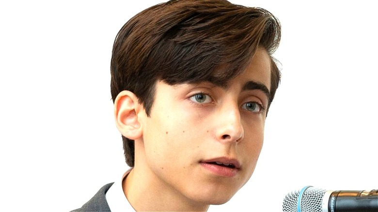 Aidan Gallagher talking into microphone