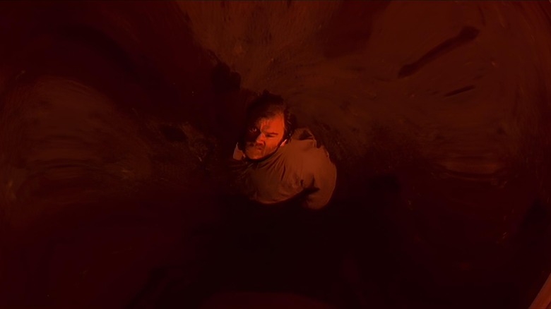 Frank stares up through blood