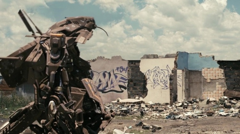 Wikus on ground in front of mech suit