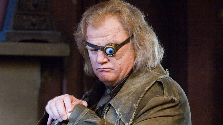 Mad-Eye Moody with his magical blue eye and cane looking down in Harry Potter and the Goblet of Fire